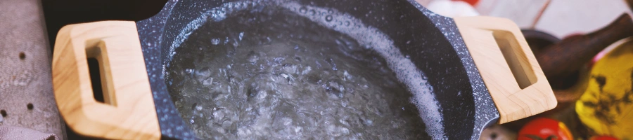 Water being boiled on a black pot