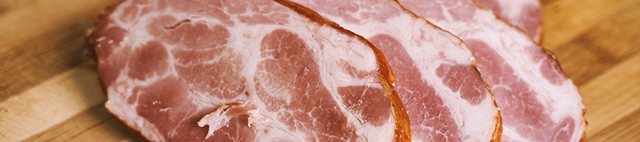 A stack of raw steak on a wooden board