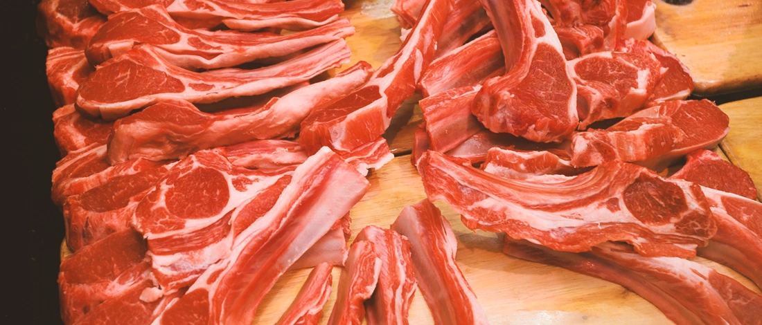 A stack of raw meat on a wooden table