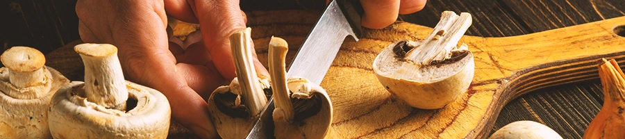 A person slicing a mushroom