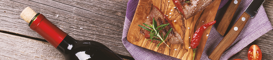 Wine and steak on a table