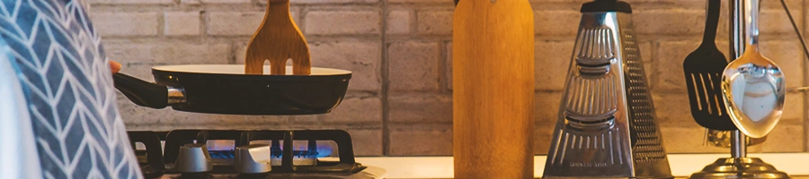 A person cooking on a pan in a kitchen