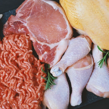 A variety of raw meat laid out on a table