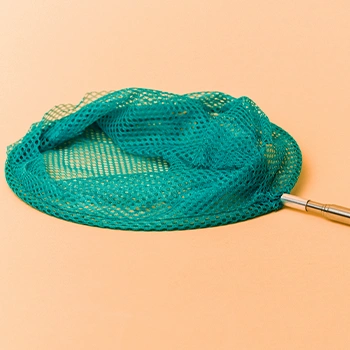 A blue fish net on a pink backdrop