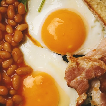 Pork and beans with egg close up