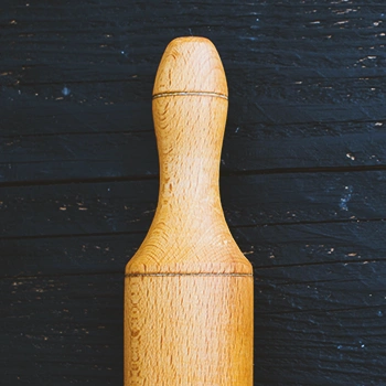 Close up shot of the handle of a rolling pin