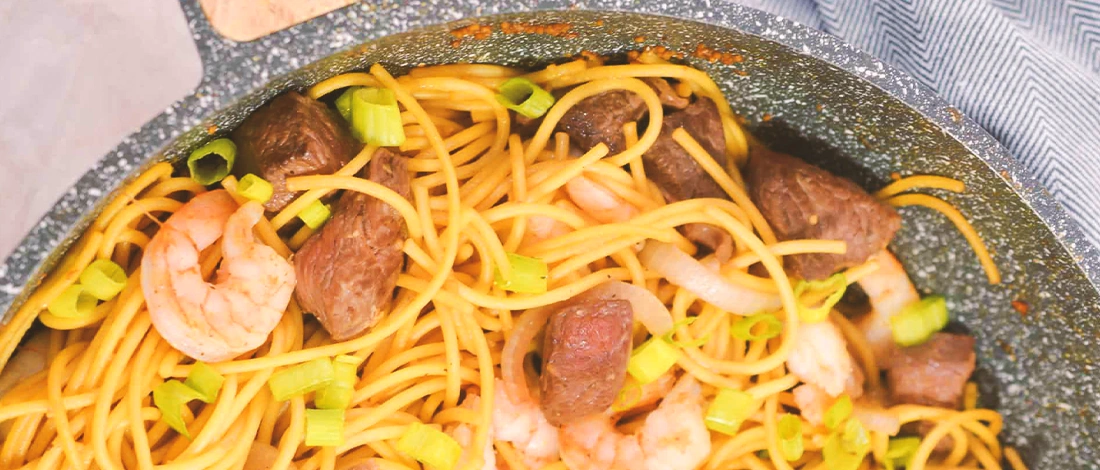 Shrimp and Steak Teriyaki noodles in a wok