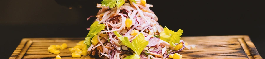 Close up shot of someone assembling coleslaw
