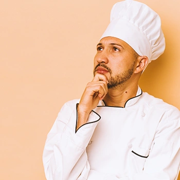 A chef thinking while looking up