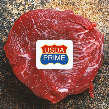 A piece of beef with the USDA Prime logo in front