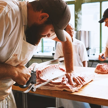 A butcher cutting up meat