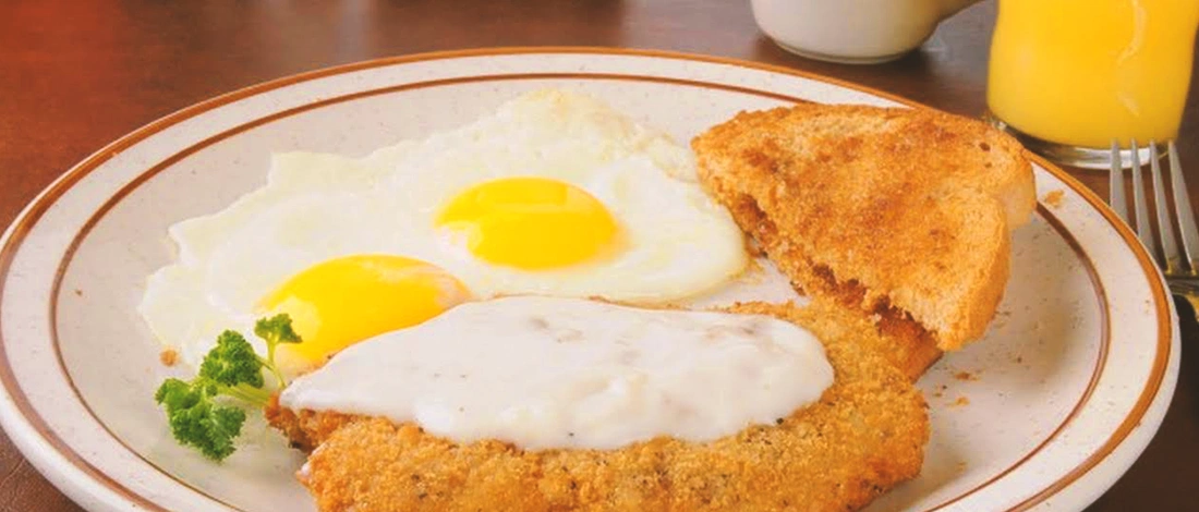Country fried steak with egg on a plate