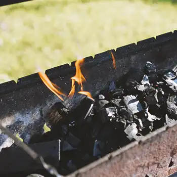 Burning charcoal on an outside grill