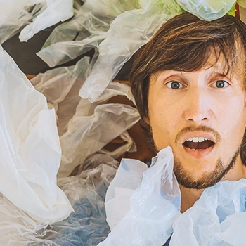A person surrounded by plastic bags