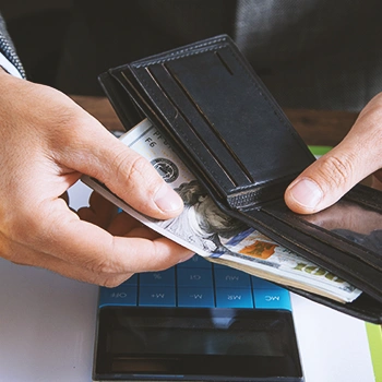 A person taking out money from his wallet