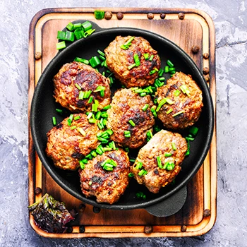 Top view of air fried meatballs on a cutting board