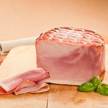 A huge sliced ham on a cutting board