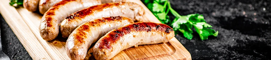 A close up image of grilled sausages on a plate