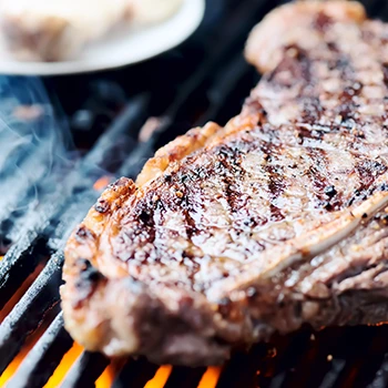 A close up image of a steak on a grill