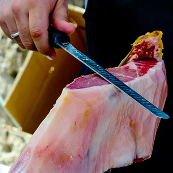 A chef skinning a huge meat