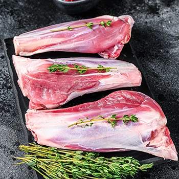 Three goat meat pieces on a cutting board