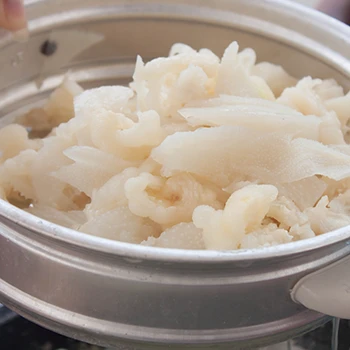 A cooked tripe meat in a stainless steamer