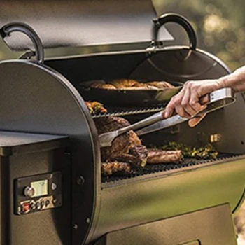 A person getting a meat from a smoker