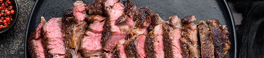 Slices of medium rare steak on a plate