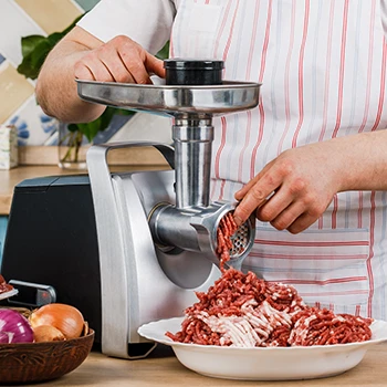 An image of a person using an electric meat grinder