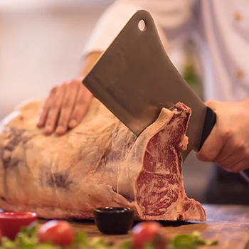 A chef slicing a huge piece of meat