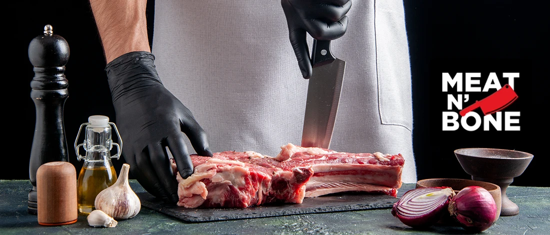 A chef slicing a huge piece of meat