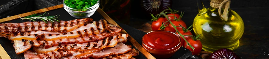 A fried bacon with tomatoes and other ingredients