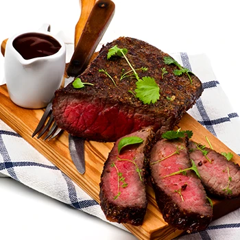 A sliced roast beef on a chopping board