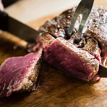 A close up image of a steak being sliced