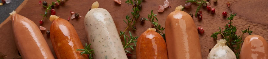 A top view of different sausages on a cutting board