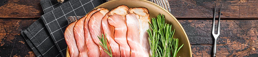 A raw bacon on a wooden bowl