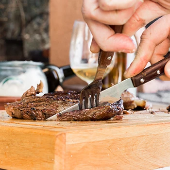 A person slicing a cooked meat