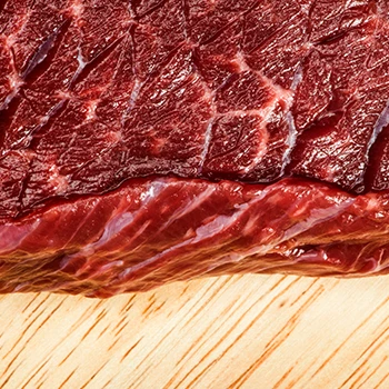 A close up view of a meat on a cutting board