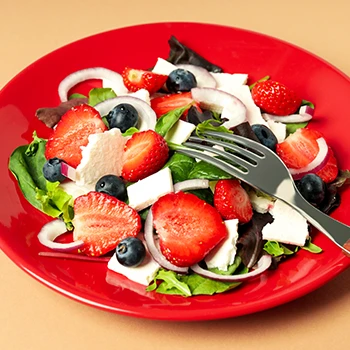 An image of vegetables and berries on a plate