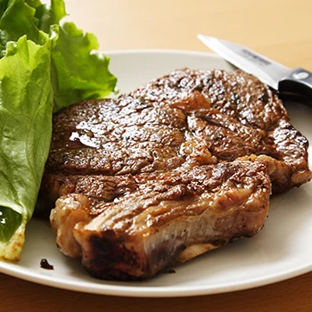 A close up image of cooked ribeye steak