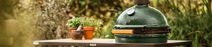 An image of Big Green Egg smoker in an outdoor setting