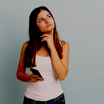 A woman thinking while holding her phone