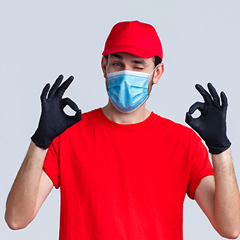 A delivery guy wearing red attire holding a hand sign