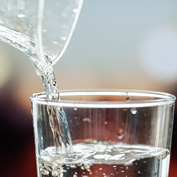 A macro shot of water being poured in a glass