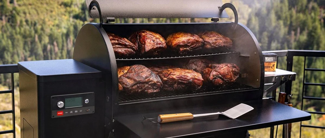 A smoker grill full of smoked meats