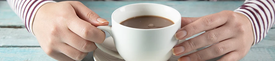 A woman holding a cup of coffee