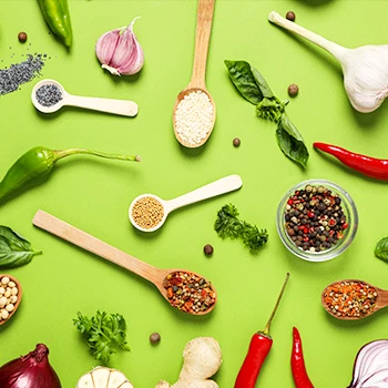 A top view image of different condiments on a spoon and bowls