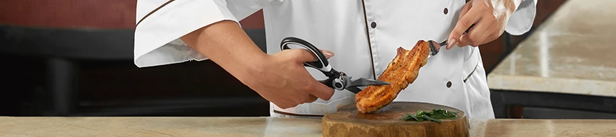 A chef cutting a cooked piece of meat