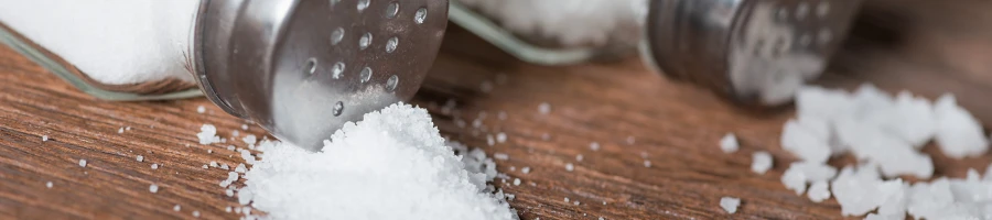 A close up image of salt and salt shakers