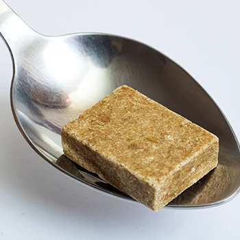 An image of beef bouillon cube on a spoon